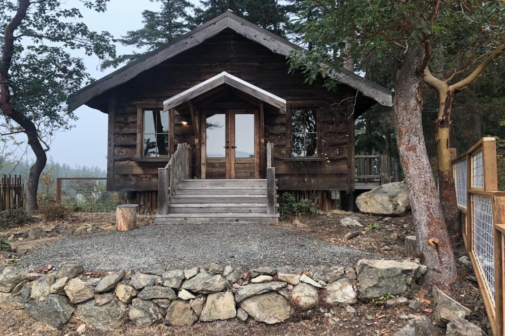 a log cabin with stairs and a porch at Little Refuge in town in Eastsound