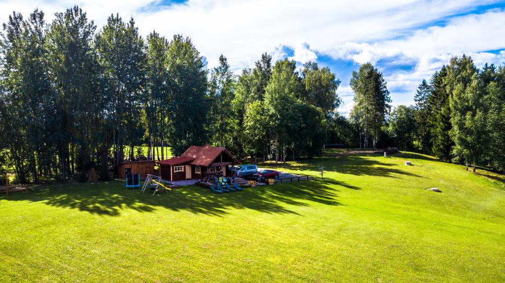 a small house in a field of green grass at Järveoru in Aidaku