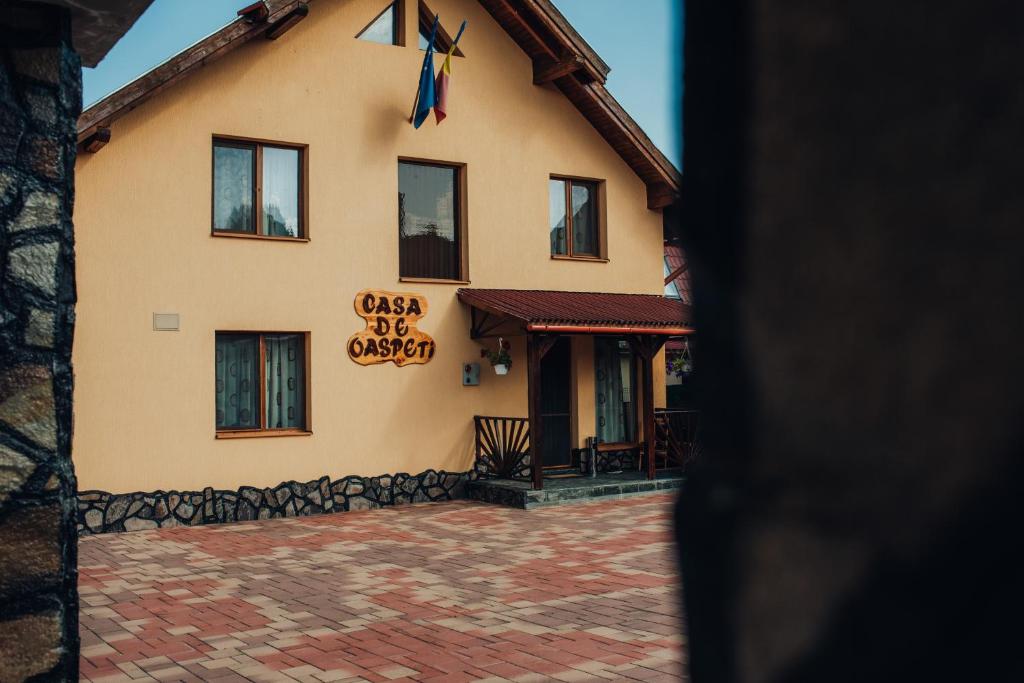 a building with a sign on the side of it at Casa de Oaspeti la Bilbor in Bilbor