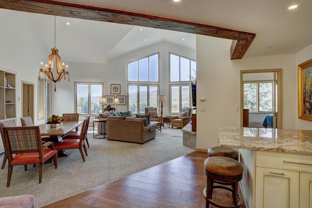 a kitchen and living room with a table and chairs at 2Br Condo In The Seasons At Arrowhead- Vaulted Ceilings Condo in Edwards