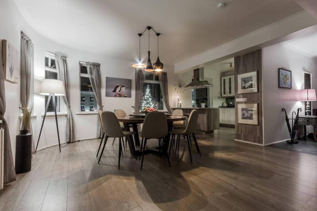 a dining room and living room with a table and chairs at Superb central location, no car needed - Spacious in Akureyri