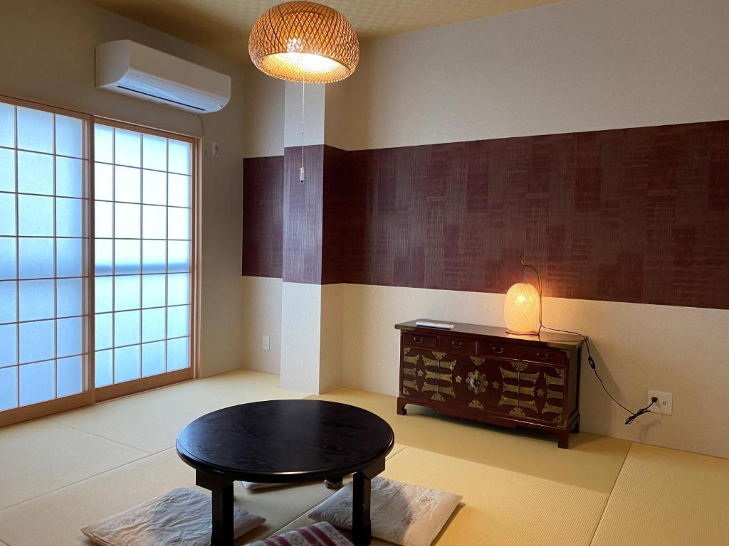 um quarto com uma mesa, um candeeiro e uma mesa em Platinum Yasaka em Quioto
