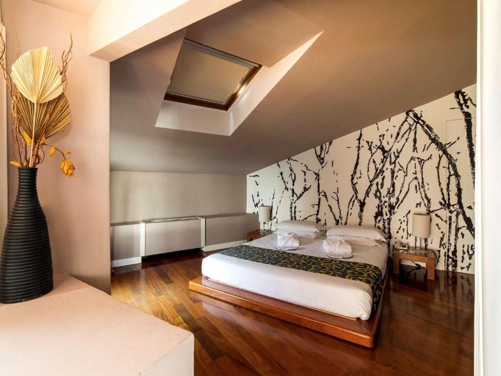 Postel nebo postele na pokoji v ubytování Hotel Ferrara