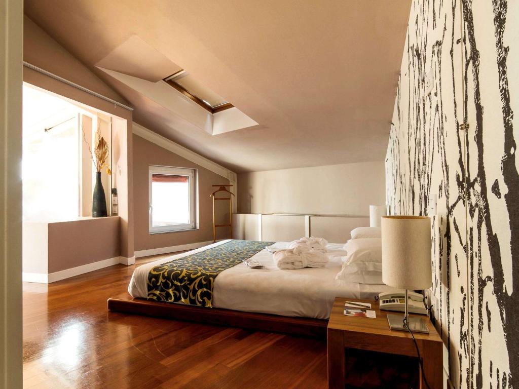 Postel nebo postele na pokoji v ubytování Hotel Ferrara