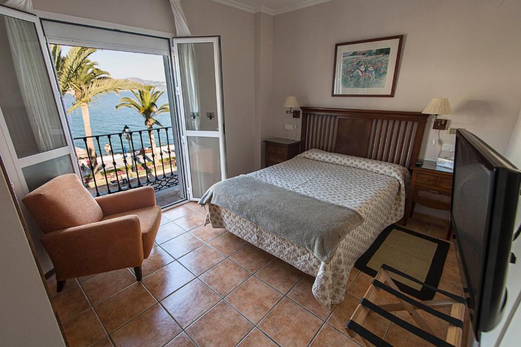 a bedroom with a bed and a chair at Marissal by Dorobe Hotels in Nerja