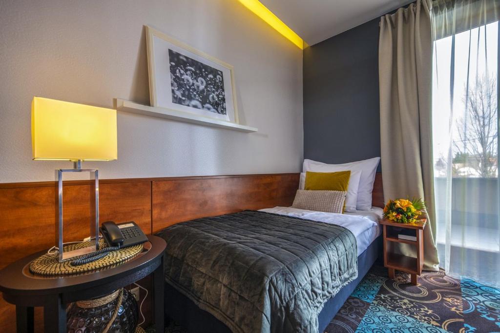 Postel nebo postele na pokoji v ubytování Budapest Airport Hotel Stáció Wellness & Konferencia