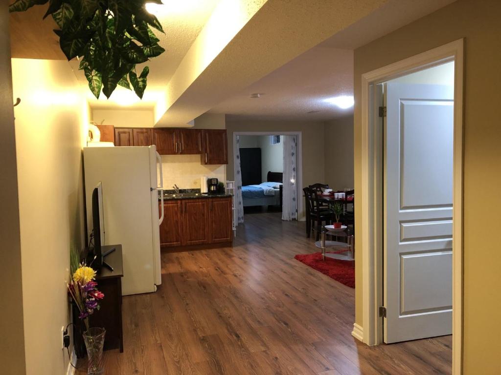 a kitchen and living room with a white refrigerator at Spacious 2 Bedroom guest suite in Toronto