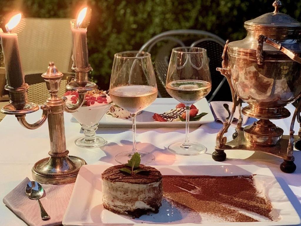 a table with wine glasses and a cake on it at Hôtel restaurant Oasis in Nice