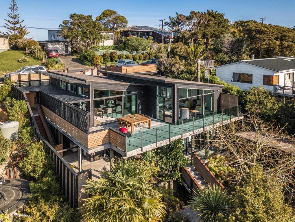 an aerial view of a house with a wrap around deck at Taonga with Sea Views by Waiheke Unlimited in Oneroa