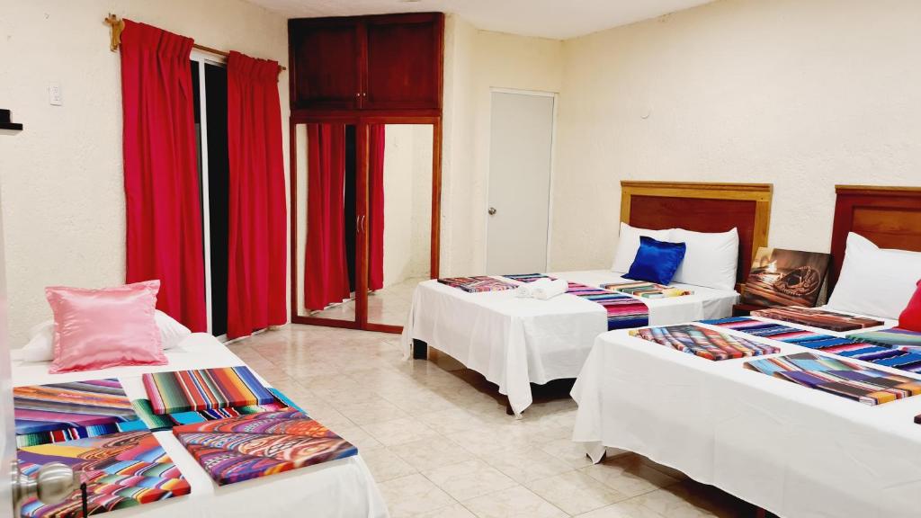 Postel nebo postele na pokoji v ubytování Hotel Machos Mahahual