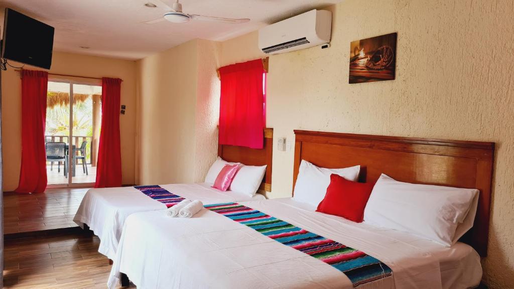 Postel nebo postele na pokoji v ubytování Hotel Machos Mahahual
