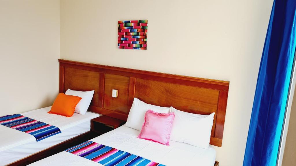 Postel nebo postele na pokoji v ubytování Hotel Machos Mahahual