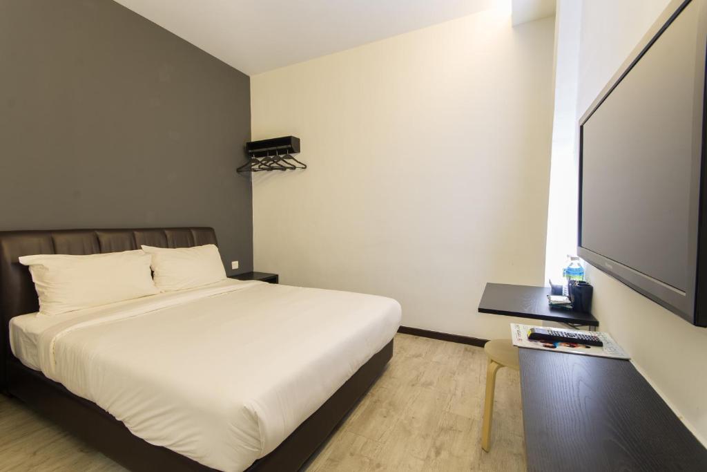Postel nebo postele na pokoji v ubytování Sandy Hotel Malacca