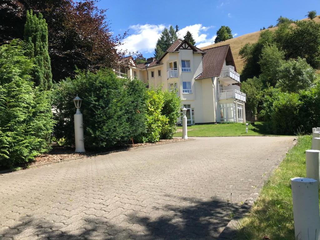 a house with a driveway in front of it at Hotel Sauerbrey in Osterode
