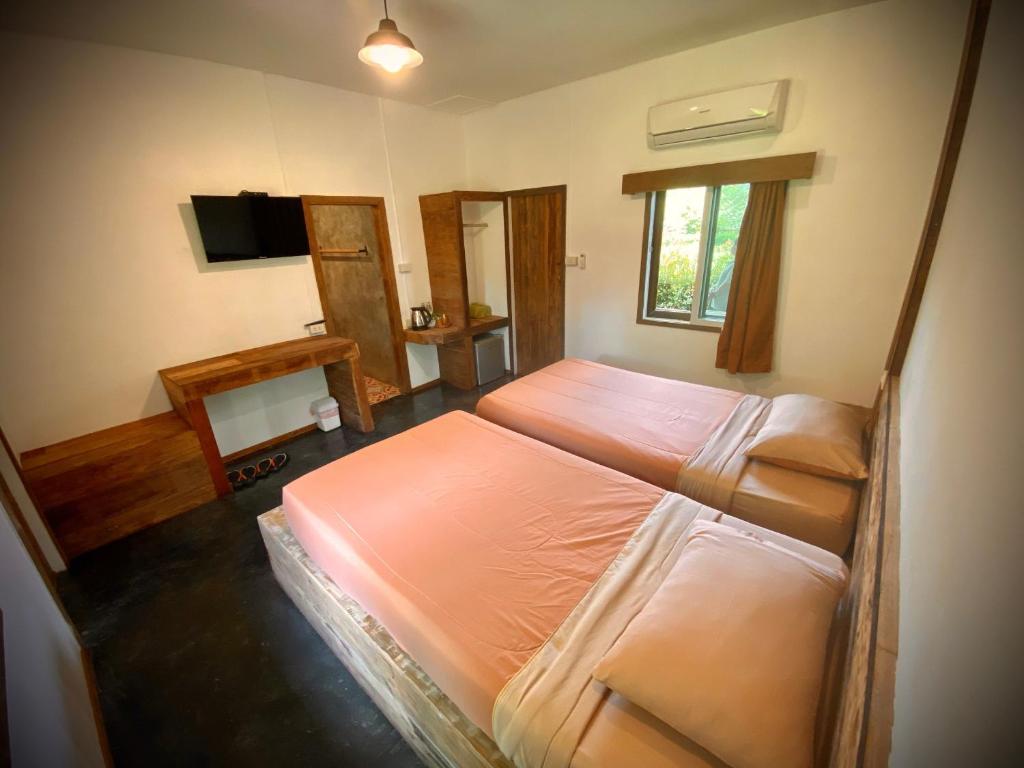 Postel nebo postele na pokoji v ubytování Sirita