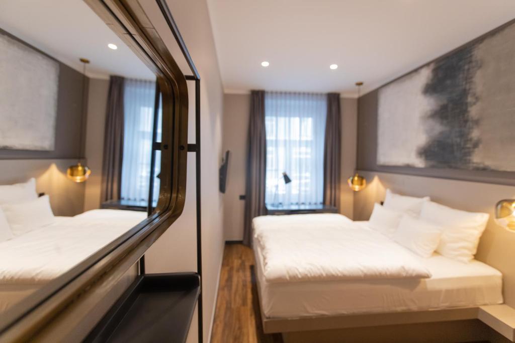 Postel nebo postele na pokoji v ubytování Munich Rooms Hotel
