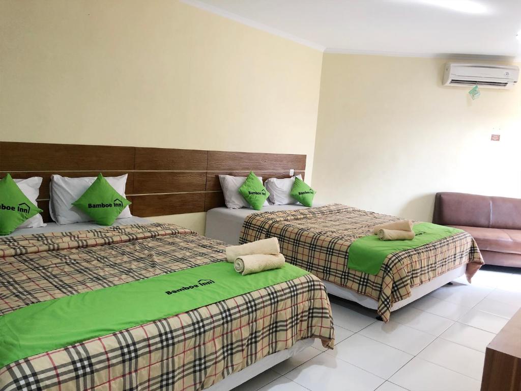 Postel nebo postele na pokoji v ubytování Bamboe Inn Homestay