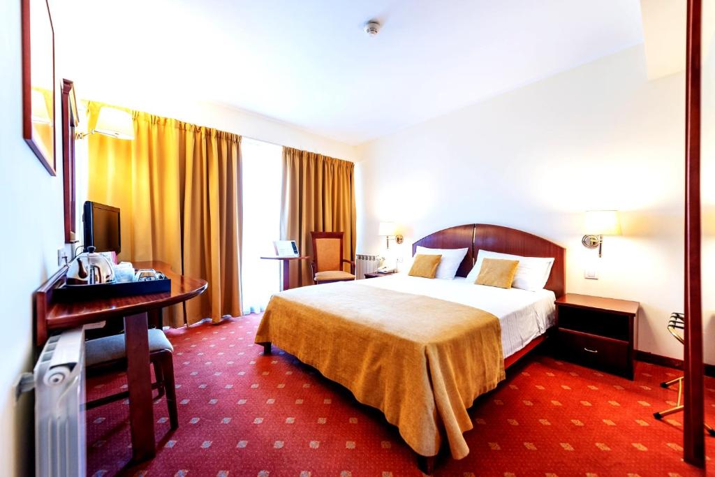 Postel nebo postele na pokoji v ubytování Hotel Minerva