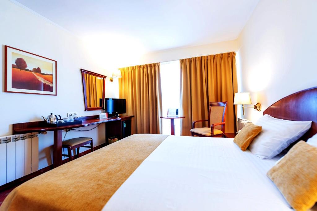 Postel nebo postele na pokoji v ubytování Hotel Minerva