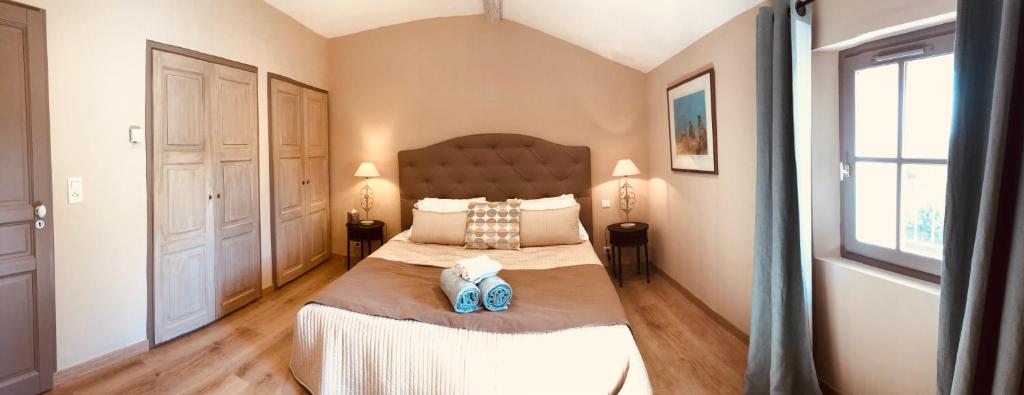 a bedroom with a large bed with two pillows at La Bri...Gite in L&#39;Isle-sur-la-Sorgue