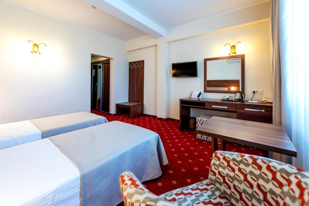 Postel nebo postele na pokoji v ubytování Hotel Minerva