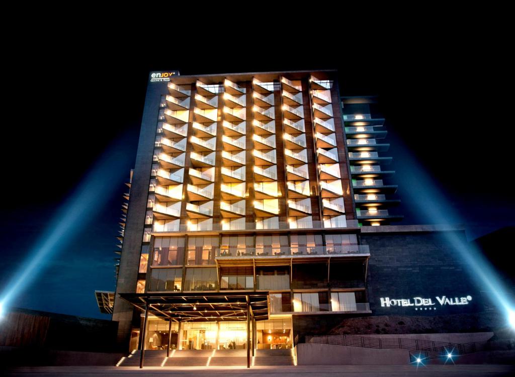 a lit up hotel building at night at Enjoy Santiago in Los Andes