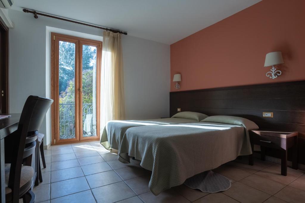 Tempat tidur dalam kamar di Hotel Don Giovanni