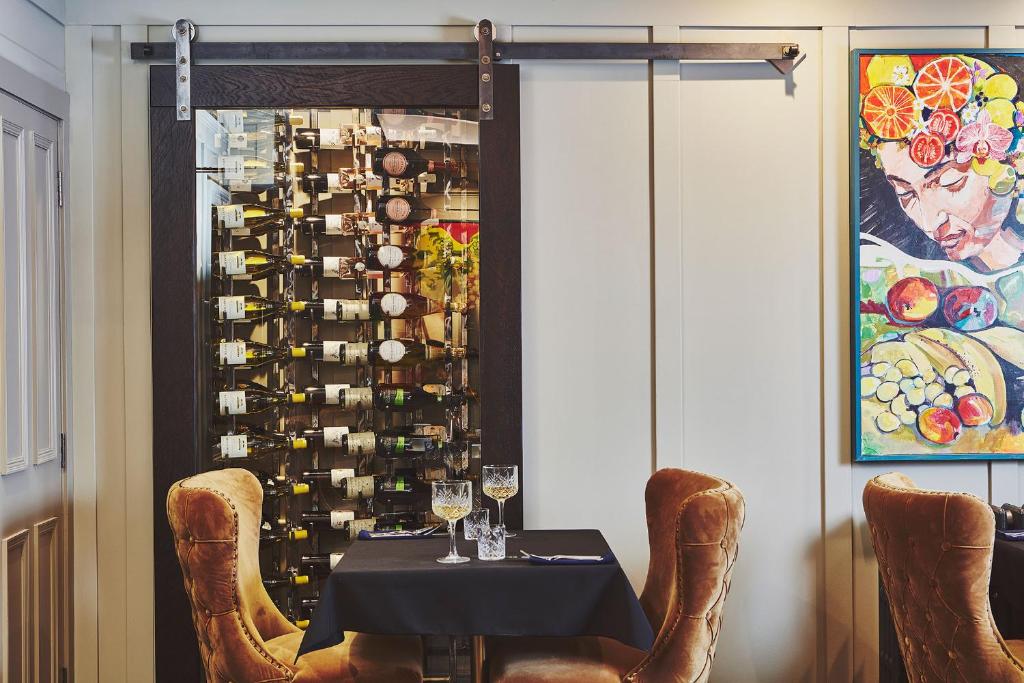 a dining room with a table and a wine cellar at No.26 By The Sea in Oban