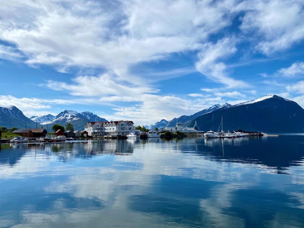 a large body of water with houses and mountains at Sunde Fjord Hotel, free and easy parking in Solavagen