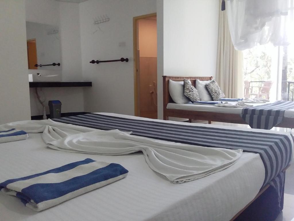 Postel nebo postele na pokoji v ubytování Sudunelum Holiday Resort