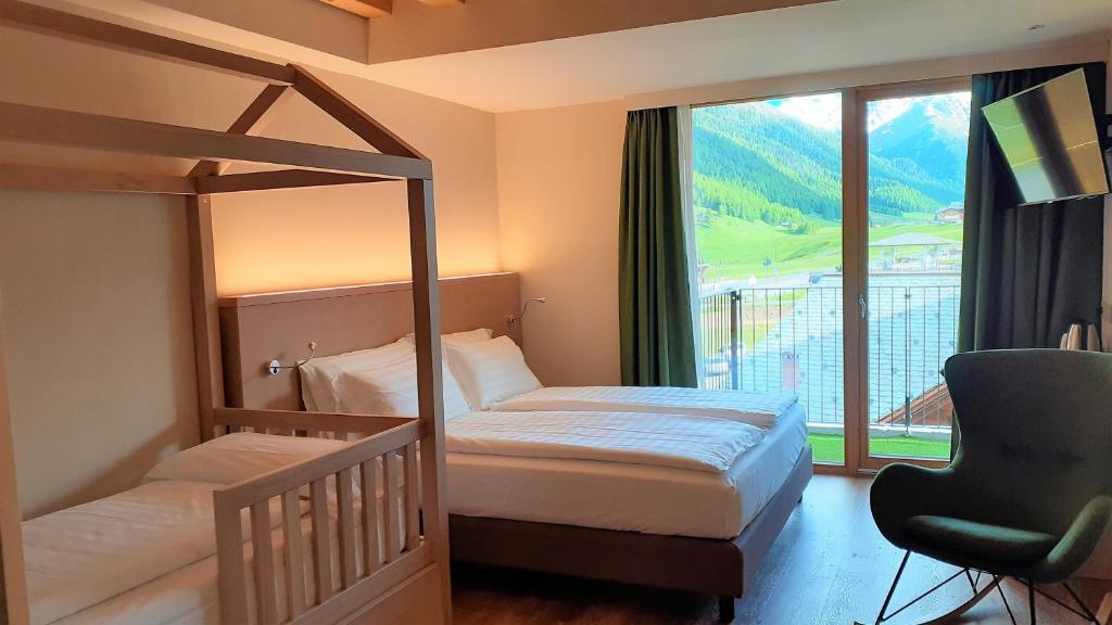 Postel nebo postele na pokoji v ubytování Livì Family Hotel