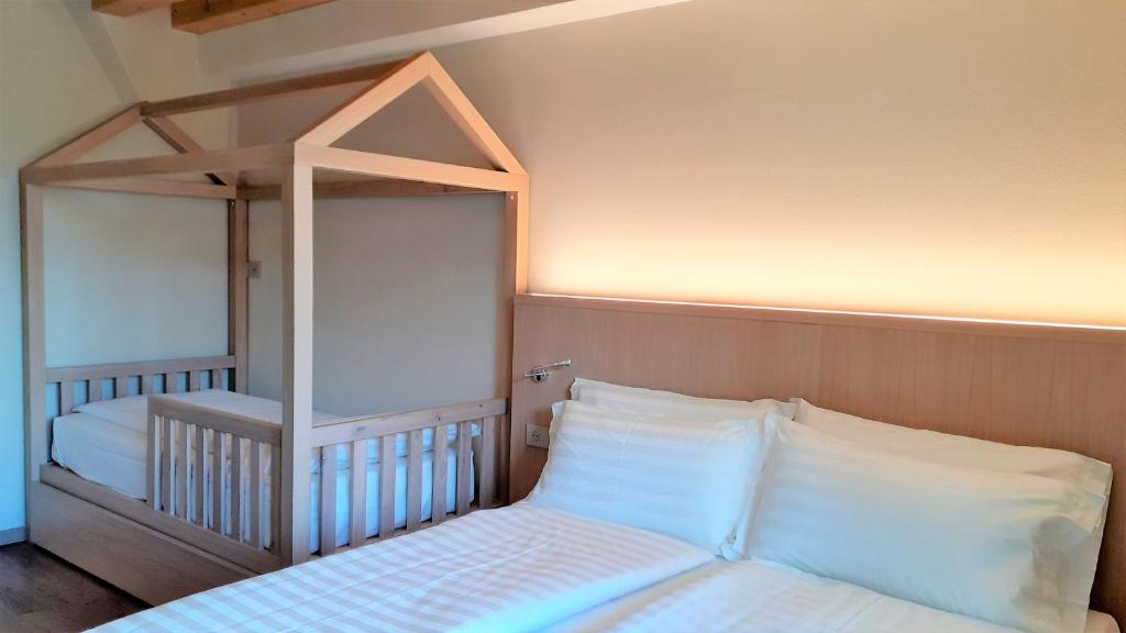 Postel nebo postele na pokoji v ubytování Livì Family Hotel