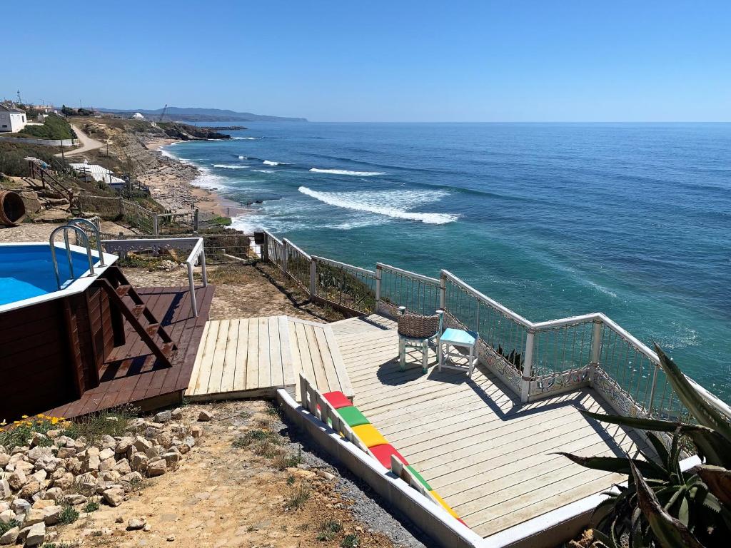 a staircase leading to the ocean with a swimming pool at Villa Ana Margarida Beach in Ericeira
