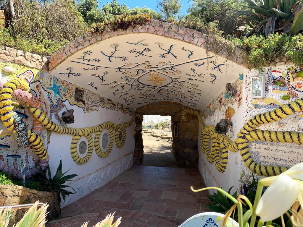 an entrance to a house with a painting on the wall at Villa Ana Margarida Beach in Ericeira