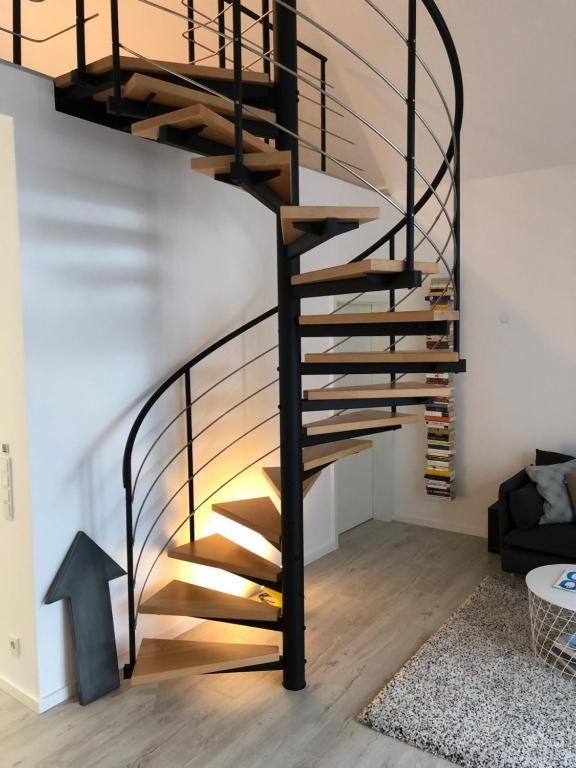 a spiral staircase in a house with a living room at Gästehaus Emma in Niederkassel