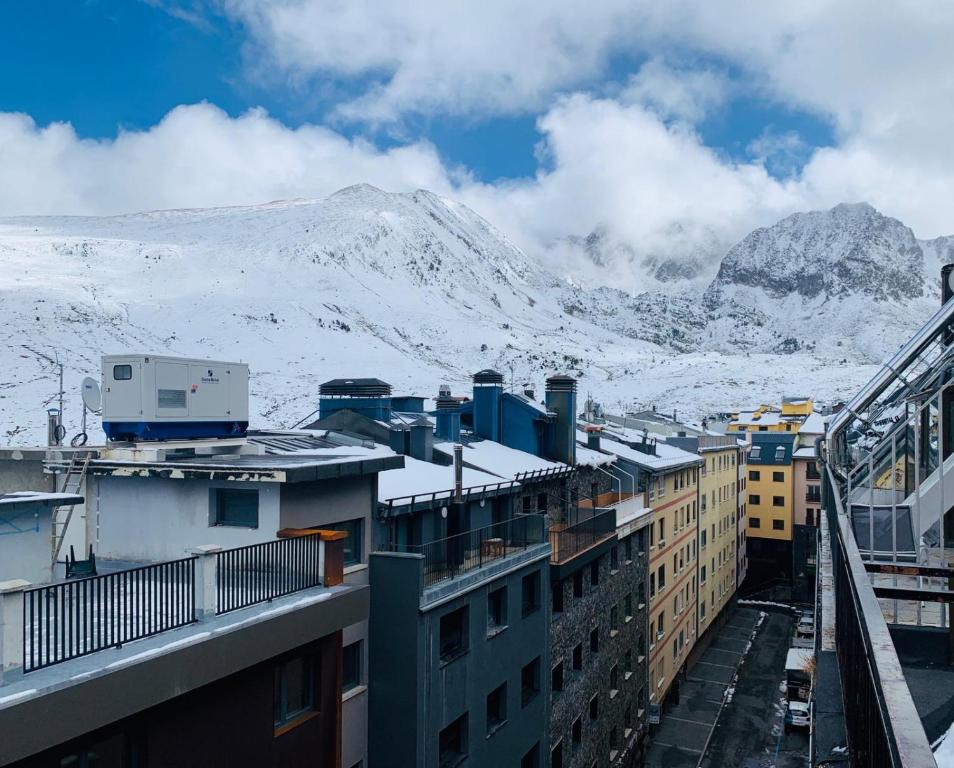 a view of snow covered mountains from a building at AC Apartaments Centre in Pas de la Casa