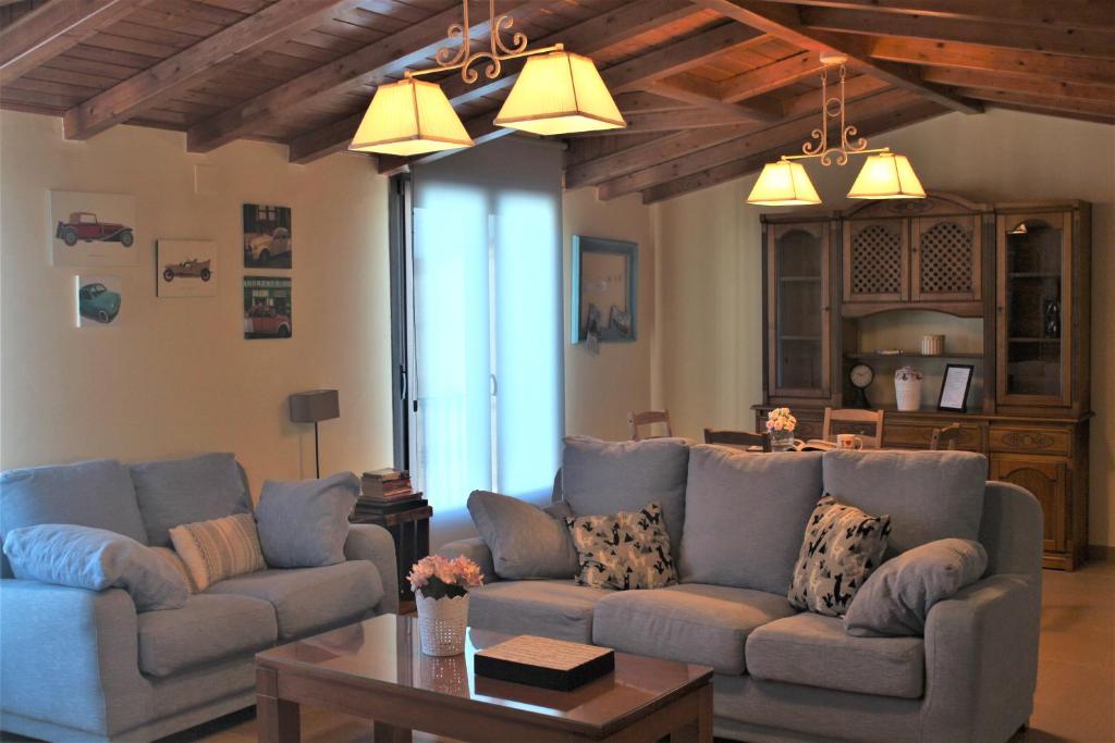 a living room with two couches and a table at EL PAJAR DE LA ABUELA in El Toboso