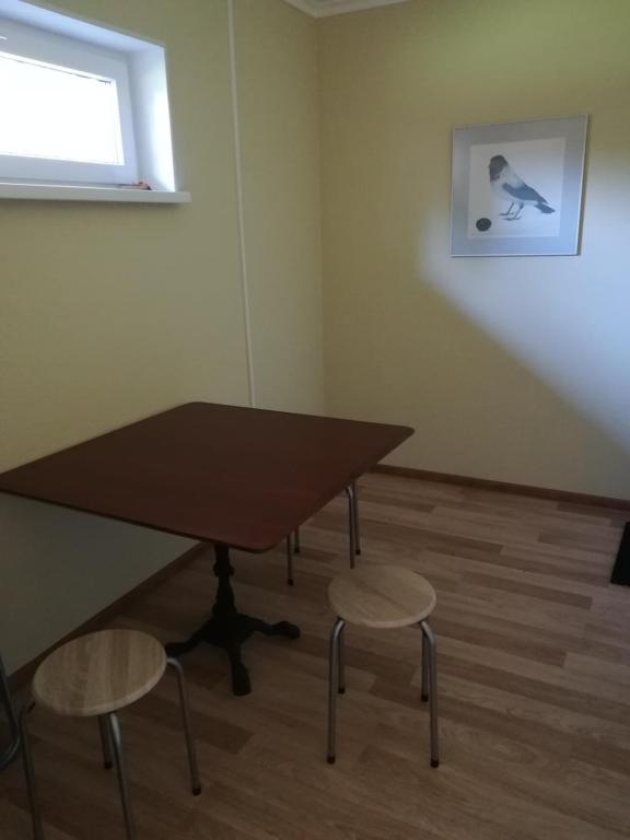 a table and two chairs in a room at Remniku Holiday Centre in Remniku