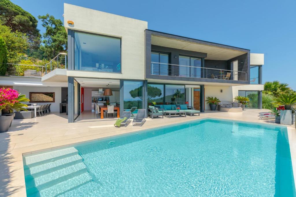 uma casa com piscina em frente a uma casa em Siview Villa em Lloret de Mar