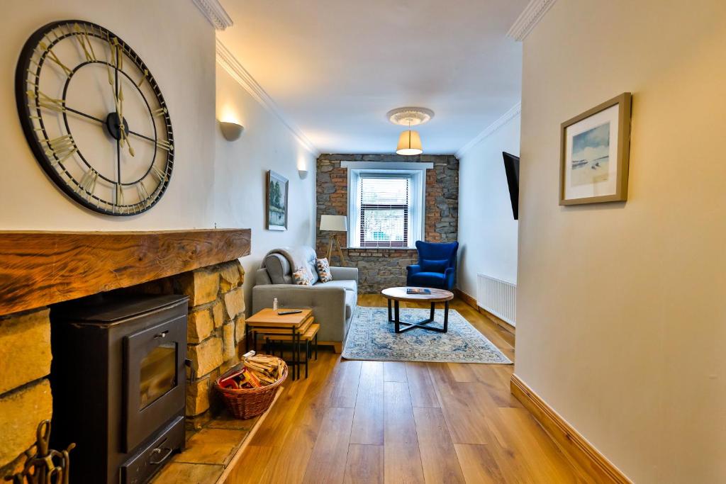 a living room with a fireplace and a clock on the wall at Union Place in Sligo