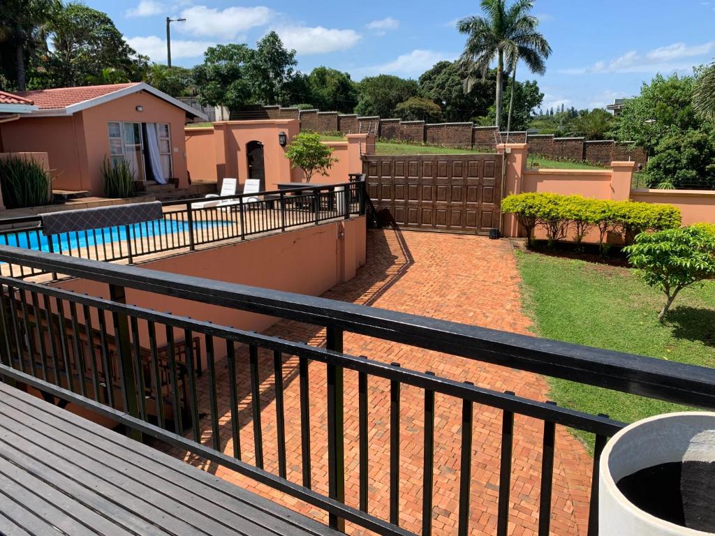 a balcony with a fence and a swimming pool at Seaview Executive Guest House in Mtunzini