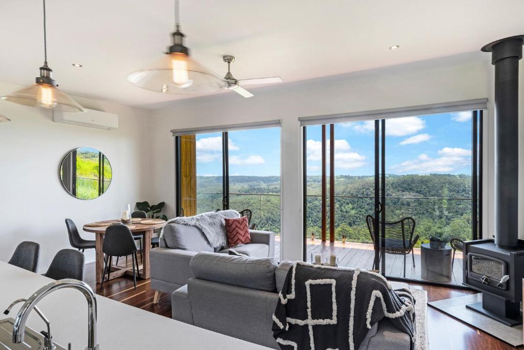 a living room with a couch and a fireplace at The Ridge at Maleny in Maleny