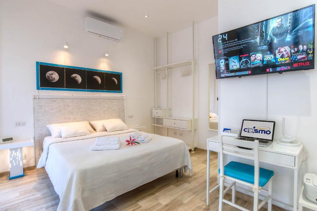 a bedroom with a bed and a tv on the wall at Appartamenti LUNA e SOLE in Rome