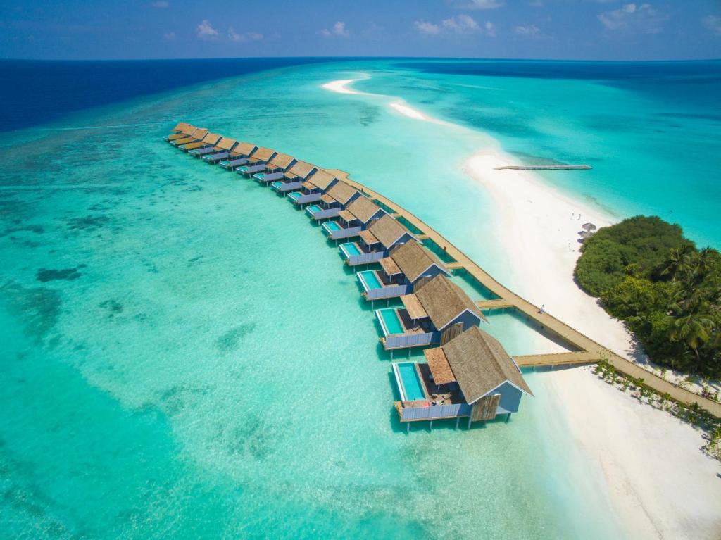 an island with a resort in the water at Kuramathi Maldives in Rasdhoo