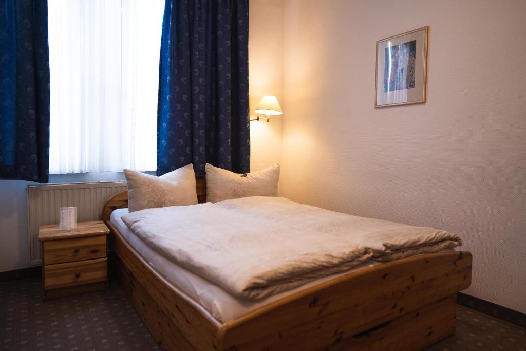 a bedroom with a bed in a room with a window at Pension am Heusteig in Stuttgart