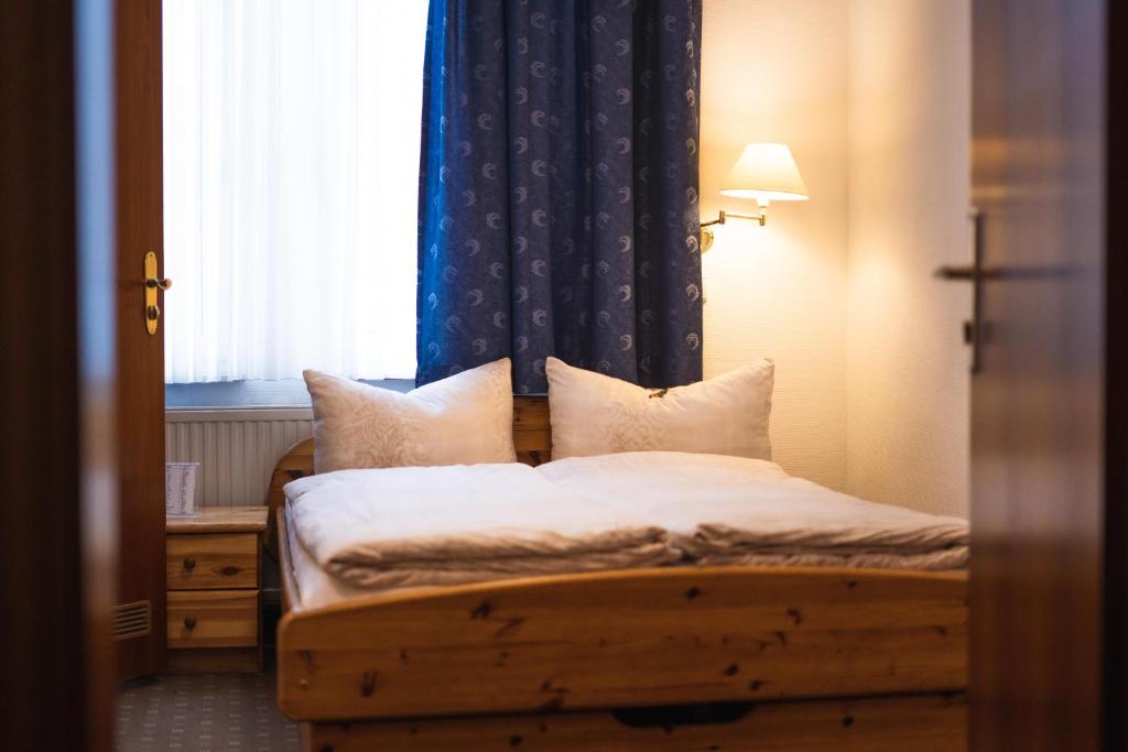 a bedroom with a bed with a window and a bed sidx sidx sidx at Pension am Heusteig in Stuttgart