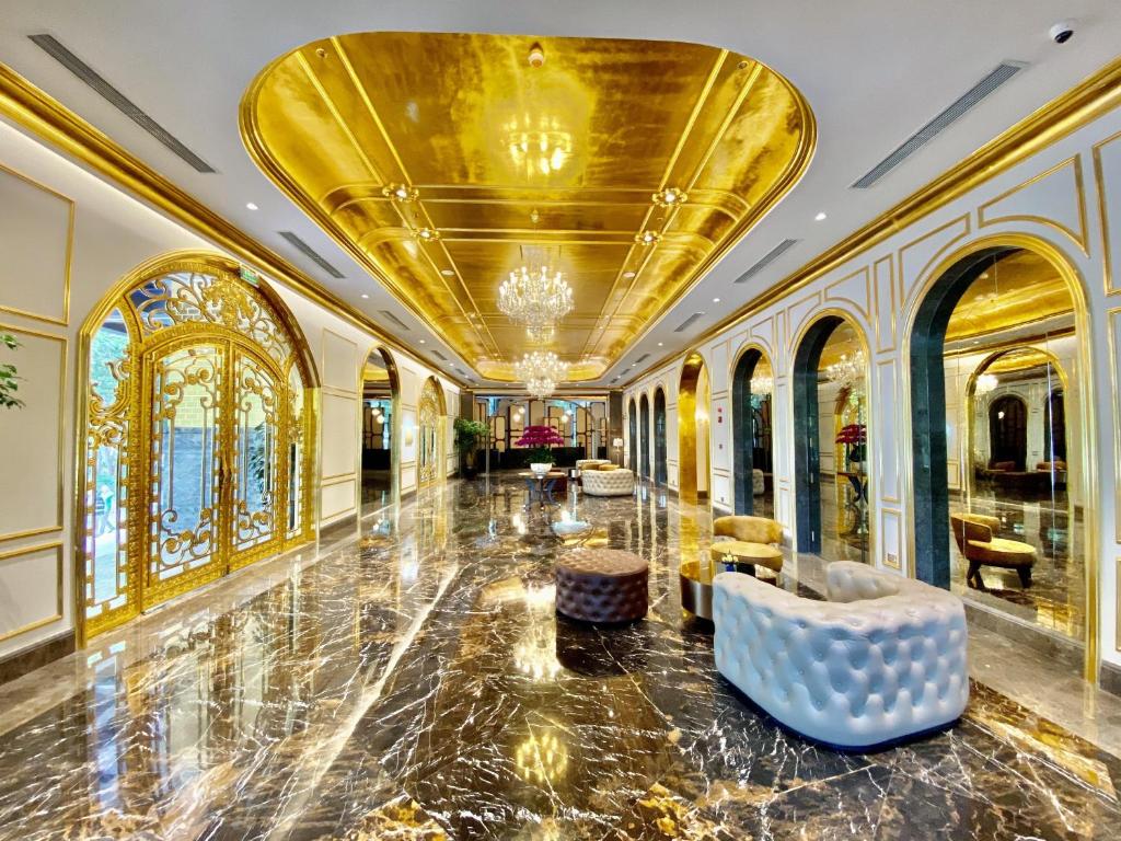 a lobby with a gold ceiling and a couch at Dolce by Wyndham Hanoi Golden Lake in Hanoi