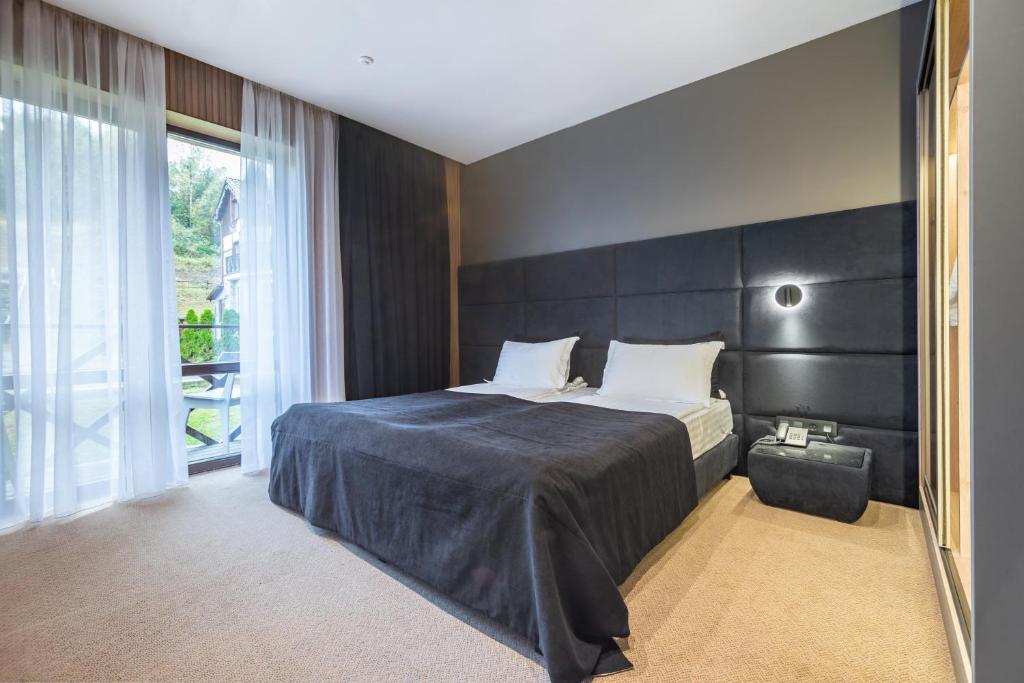 Postel nebo postele na pokoji v ubytování MK Resort (ex. Magiya Karpat)