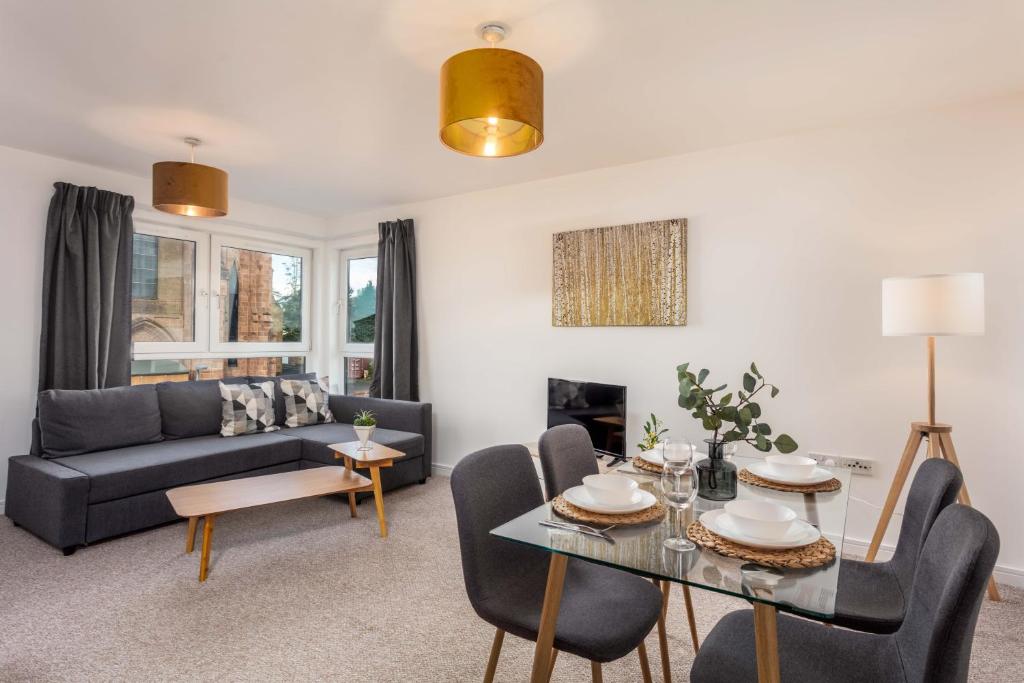 a living room with a couch and a table at Walker Suite No53 - Donnini Apartments in Kilmarnock