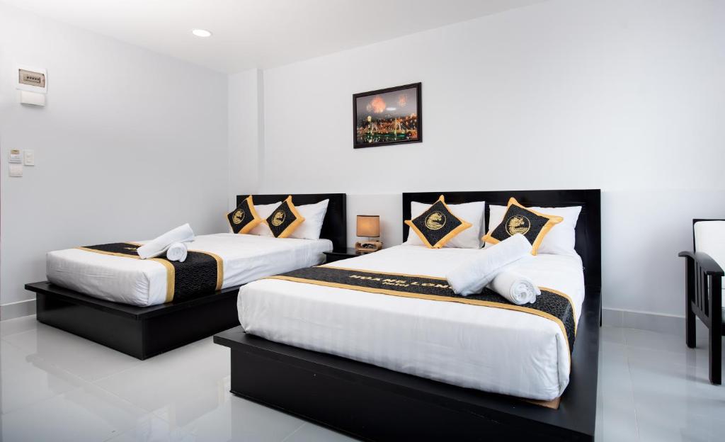 Giường trong phòng chung tại Hoang Long Hotel Phan Thiết